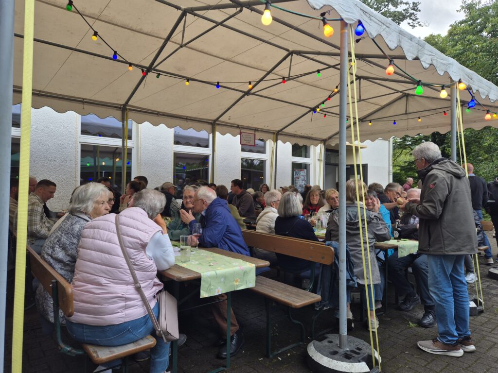 Menschen an Bierzeltgarnituren